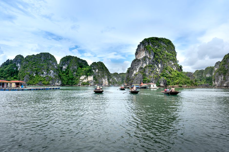 Tranquil scene of boats navigating the limestone karsts in beautiful Halong Bay, Vietnam. (photo by Quang Nguyen Vinh on Pexels)