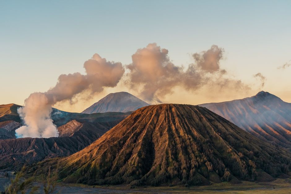Sunrise over Mount Bromo in East Java, showcasing volcanic landscape and steam clouds. (photo by Daneswara Eka on Pexels)