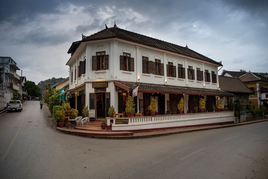 Elegant colonial-style building at a street corner in Luang Prabang, Laos, under cloudy skies. (photo by Stephen Leonardi on Pexels)