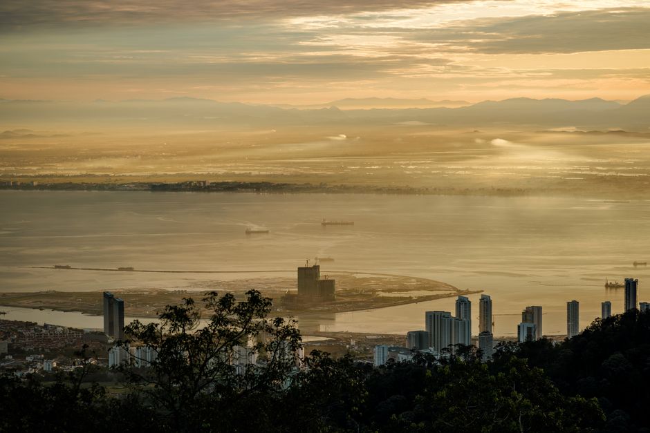 Stunning sunrise view over Penang from Bukit Bendera, Malaysia featuring skyscrapers and the coastline. (photo by Richard L on Pexels)
