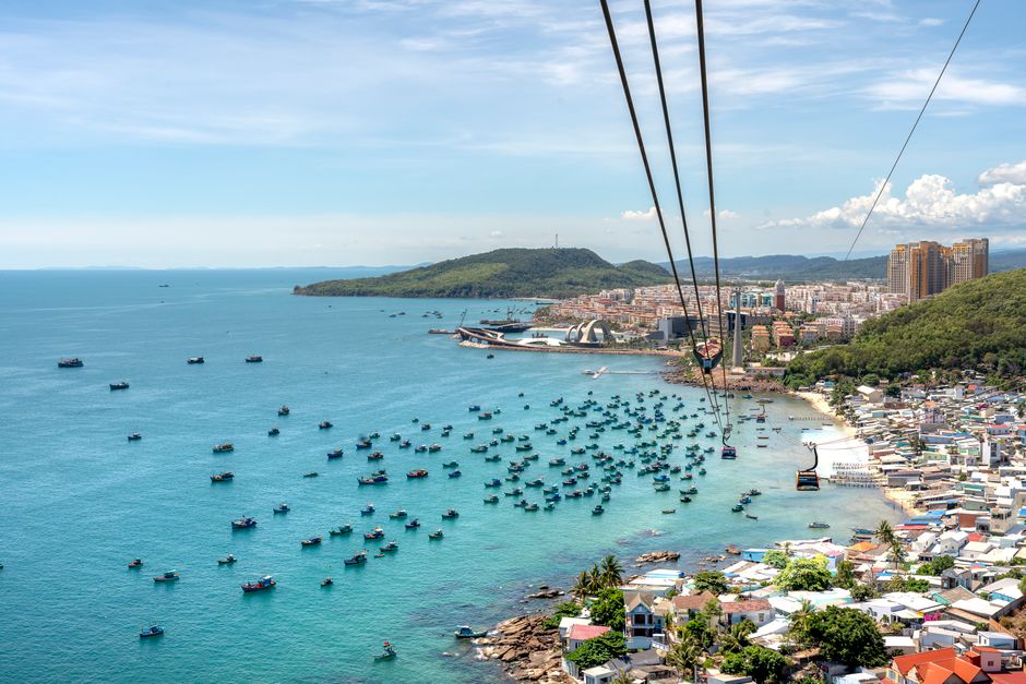 A breathtaking aerial view of Phu Quoc Island with boats, coastline, and cable car over blue water. (photo by Quang Nguyen Vinh on Pexels)